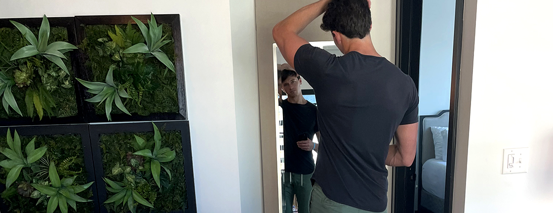 Connor Saeli combing his hair in Delancy mirror